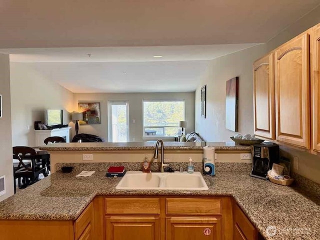 1600 W Ocean Ave Unit 1236, Westport, WA 98595 - kitchen with a sink, open floor plan, light stone counters, and a peninsula