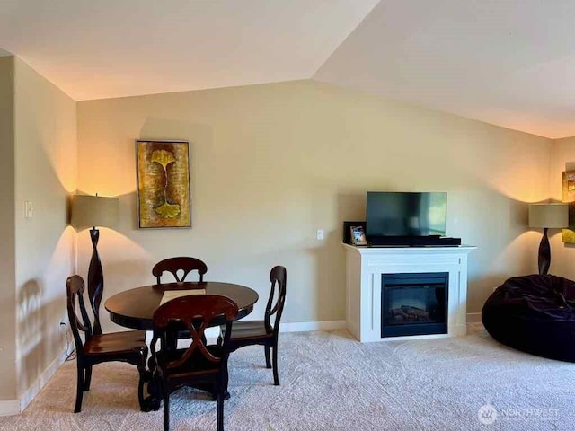 1600 W Ocean Ave Unit 1236, Westport, WA 98595 - carpeted dining area featuring baseboards, a glass covered fireplace, and lofted ceiling