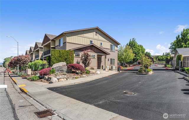 1051 N Baker Ave Unit B204, East Wenatchee, WA 98802 - view of asphalt street featuring curbs, a gate, sidewalks, and street lights