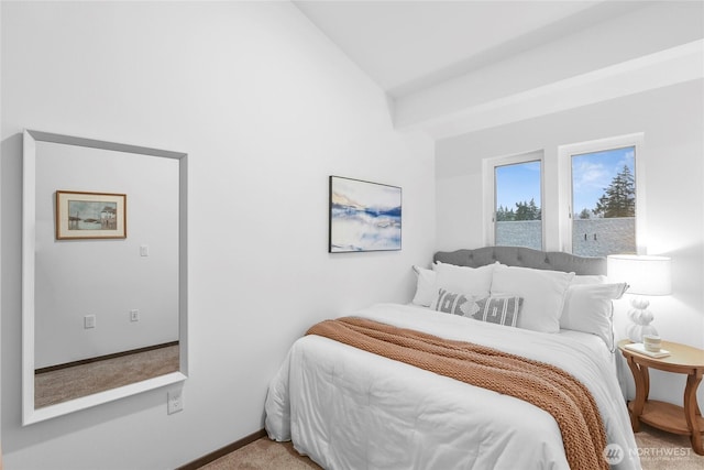 bedroom with lofted ceiling and carpet