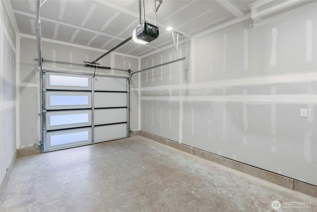 garage with a garage door opener and baseboards