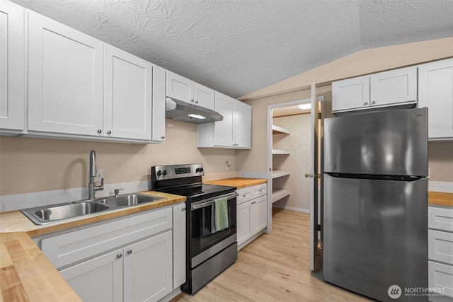 260 E Tahuya Dr, Shelton, WA 98584 - kitchen featuring butcher block countertops, appliances with stainless steel finishes, a sink, under cabinet range hood, and vaulted ceiling