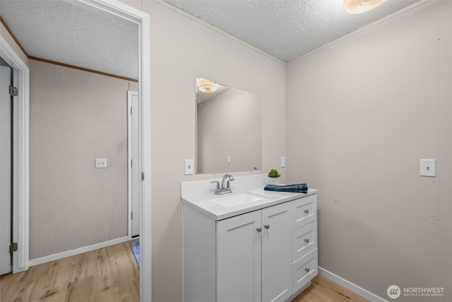 260 E Tahuya Dr, Shelton, WA 98584 - bathroom with wood finished floors, vanity, baseboards, and ornamental molding