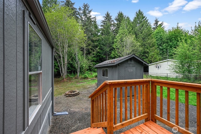 260 E Tahuya Dr, Shelton, WA 98584 - wooden deck with a fire pit, fence, and an outdoor structure