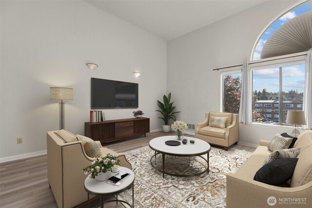 3501 Colby Ave Unit 301, Everett, WA 98201 - living room featuring wood finished floors, baseboards, and a high ceiling