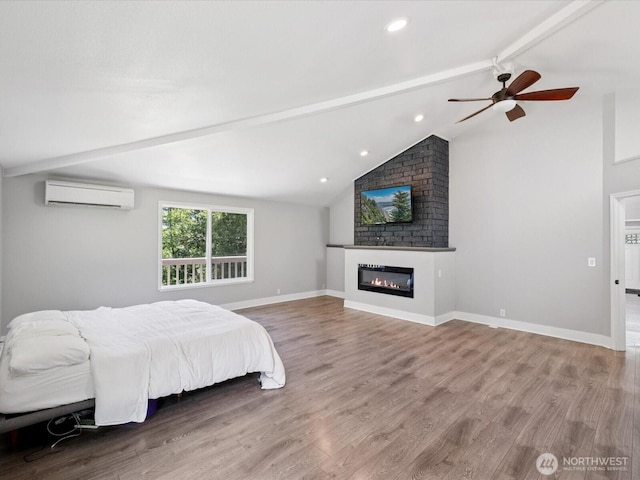 7315 294th St NE, Arlington, WA 98223 - bedroom featuring a wall mounted air conditioner, wood finished floors, a fireplace, recessed lighting, and a ceiling fan