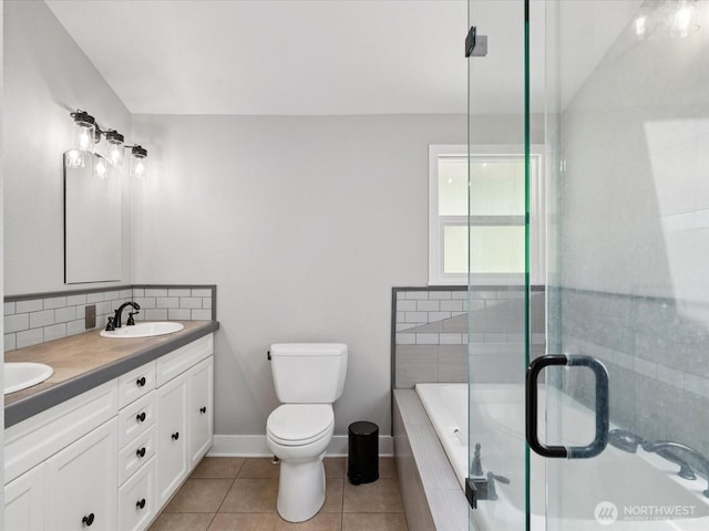 7315 294th St NE, Arlington, WA 98223 - bathroom with tiled tub, double vanity, a shower with door, tile patterned flooring, and backsplash