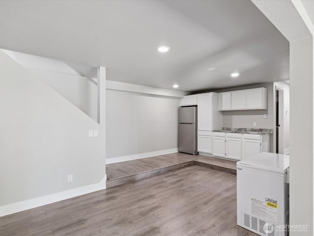 7315 294th St NE, Arlington, WA 98223 - kitchen with freestanding refrigerator, refrigerator, white cabinets, light wood-type flooring, and recessed lighting