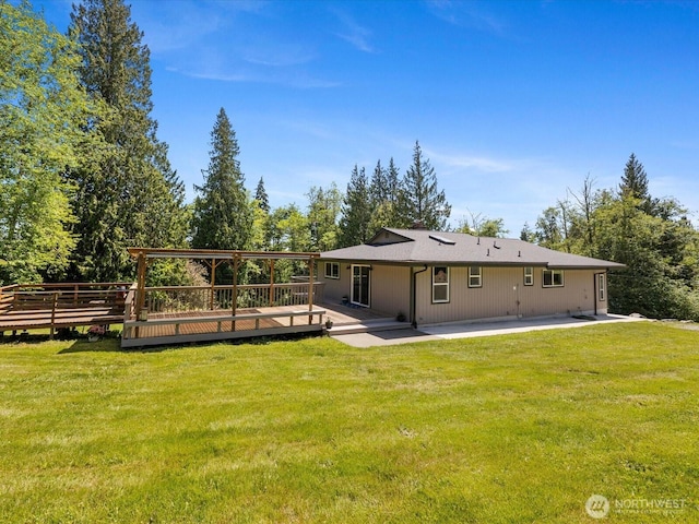 7315 294th St NE, Arlington, WA 98223 - rear view of property featuring a wooden deck, a yard, and a patio