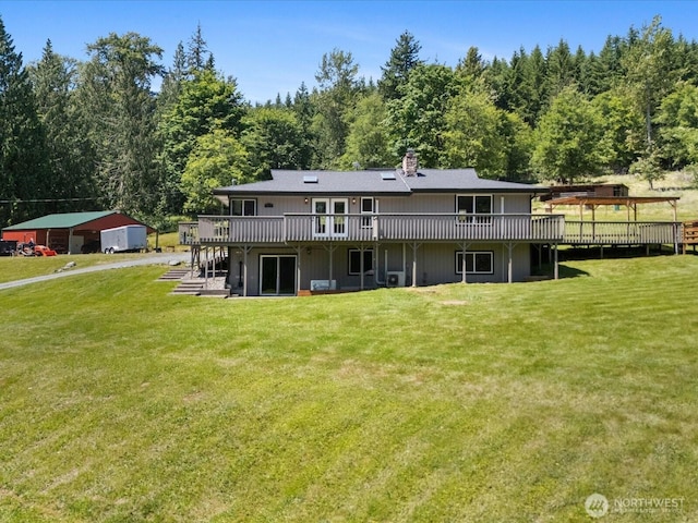 7315 294th St NE, Arlington, WA 98223 - rear view of property with a wooden deck, a lawn, a chimney, and a view of trees