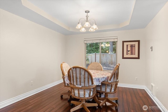 447 E Pointes Dr E, Shelton, WA 98584 - dining room featuring a chandelier, a tray ceiling, dark wood-style floors, and baseboards