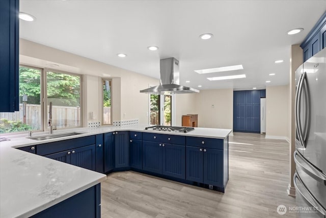 447 E Pointes Dr E, Shelton, WA 98584 - kitchen with island range hood, a sink, appliances with stainless steel finishes, a skylight, and healthy amount of natural light