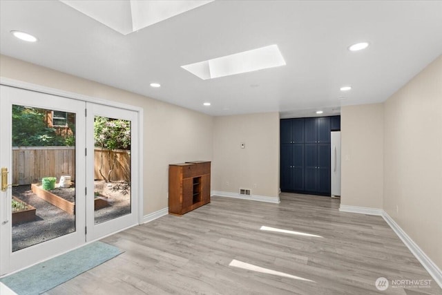 447 E Pointes Dr E, Shelton, WA 98584 - unfurnished living room featuring a skylight, light wood finished floors, baseboards, and recessed lighting
