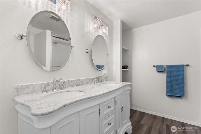 447 E Pointes Dr E, Shelton, WA 98584 - bathroom featuring double vanity, wood finished floors, and baseboards