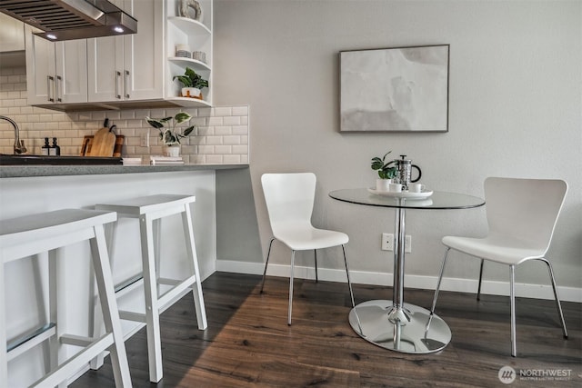 769 Hayes St Unit 504, Seattle, WA 98109 - dining area featuring baseboards and dark wood-style floors