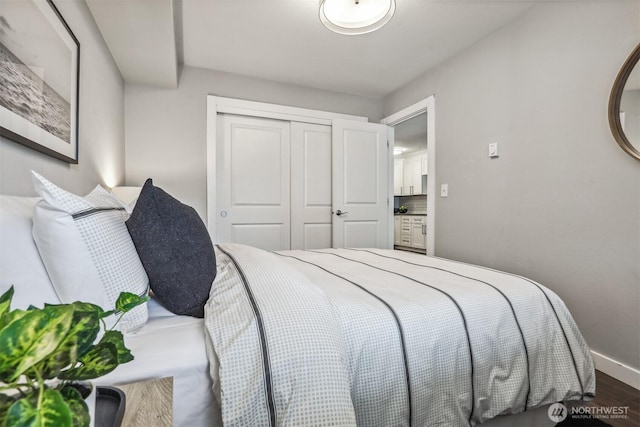 769 Hayes St Unit 504, Seattle, WA 98109 - bedroom with a closet, wood finished floors, and baseboards