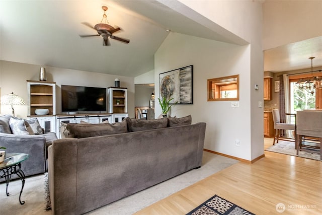 2634 59th Ave NW, Olympia, WA 98502 - living area with ceiling fan, high vaulted ceiling, light wood-style flooring, and a chandelier