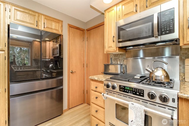 2634 59th Ave NW, Olympia, WA 98502 - kitchen with stainless steel appliances, light brown cabinets, and tasteful backsplash