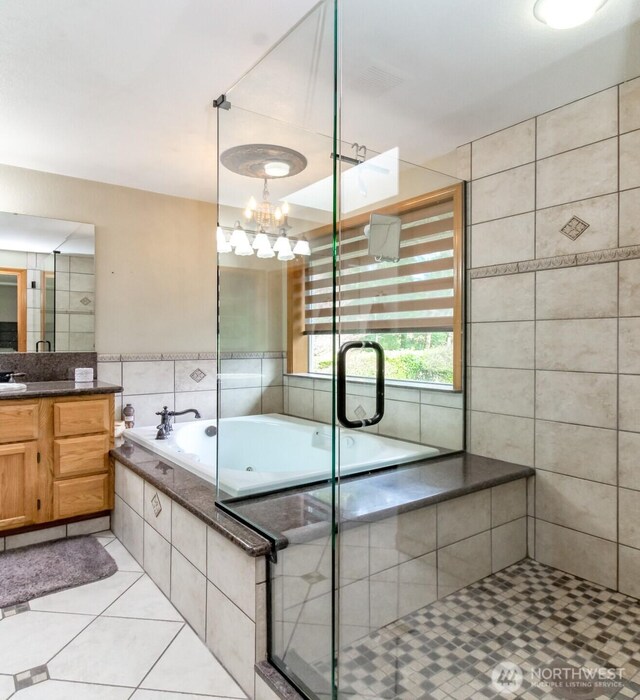 2634 59th Ave NW, Olympia, WA 98502 - bathroom featuring tile patterned flooring, vanity, a bath, tile walls, and a stall shower