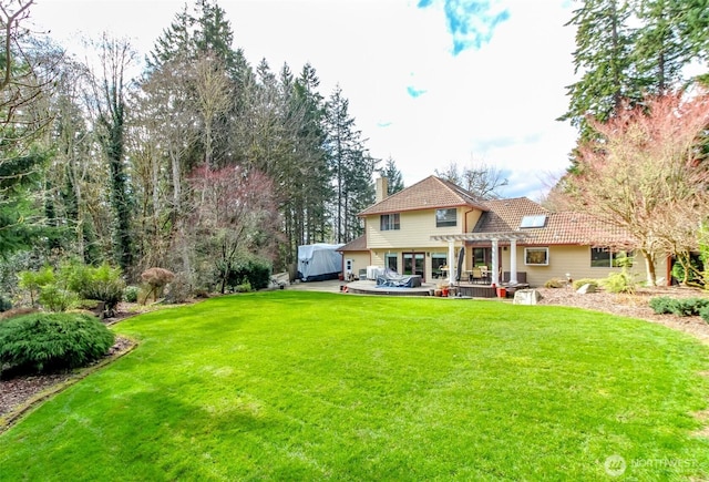 2634 59th Ave NW, Olympia, WA 98502 - rear view of house featuring a pergola, a chimney, a yard, and a tile roof