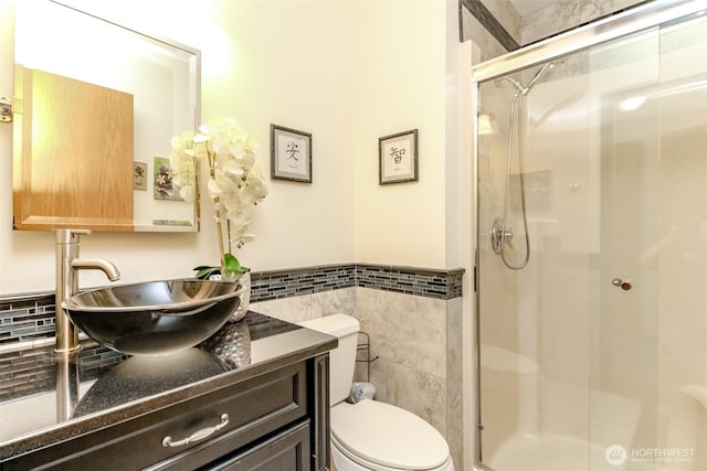 2634 59th Ave NW, Olympia, WA 98502 - bathroom with tile walls, a stall shower, vanity, and a wainscoted wall