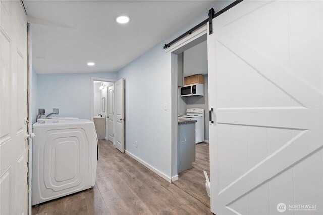 1140 Tacoma Ave, Port Orchard, WA 98366 - clothes washing area featuring washer / clothes dryer, light wood-style flooring, baseboards, recessed lighting, and a barn door