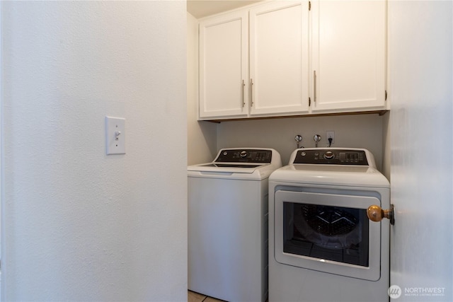 laundry room featuring independent washer and dryer and cabinet space