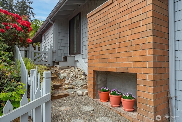 view of home's exterior with fence and entry steps