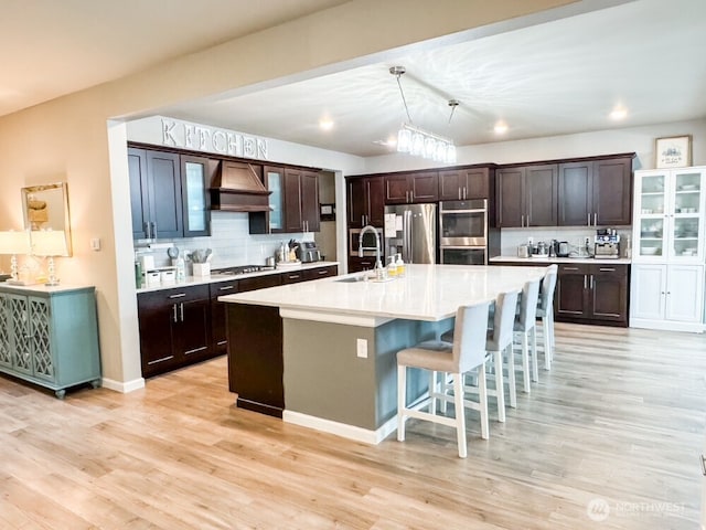 32938 Ash Ave SE, Black Diamond, WA 98010 - kitchen with a sink, stainless steel appliances, custom range hood, tasteful backsplash, and light countertops