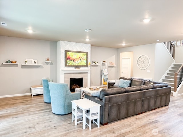 32938 Ash Ave SE, Black Diamond, WA 98010 - living room featuring a fireplace, light wood-style floors, stairs, and baseboards