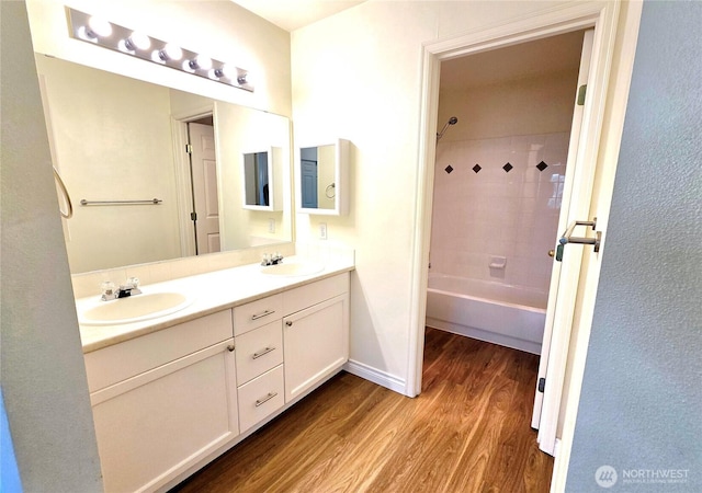 18501 SE Newport Way Unit H335, Issaquah, WA 98027 - full bathroom featuring wood finished floors, double vanity, shower / bath combination, and baseboards