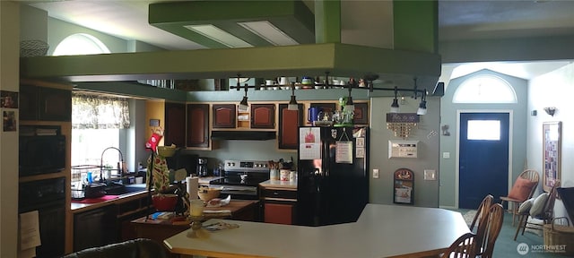 19425 Grant Rd NW, Soap Lake, WA 98851 - kitchen featuring black refrigerator with ice dispenser, under cabinet range hood, stainless steel electric stove, and plenty of natural light