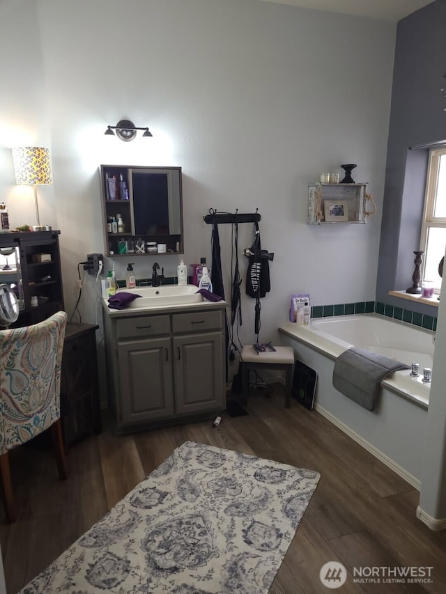 19425 Grant Rd NW, Soap Lake, WA 98851 - full bathroom featuring wood finished floors, a garden tub, vanity, and baseboards