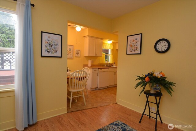 1605 7th Ave, Longview, WA 98632 - hallway featuring plenty of natural light, light wood-style flooring, baseboards, and a sink