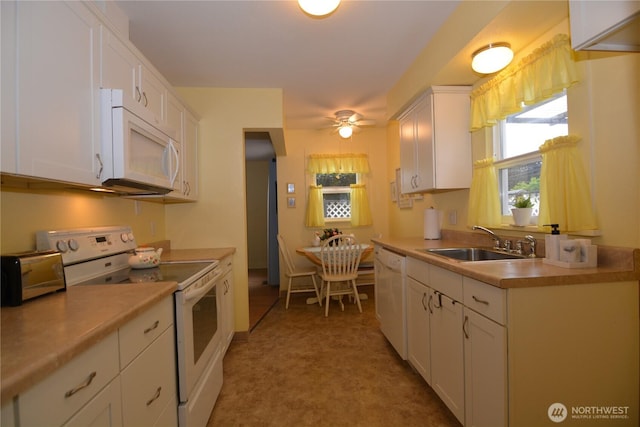 1605 7th Ave, Longview, WA 98632 - kitchen with white appliances, a sink, white cabinets, a ceiling fan, and light countertops