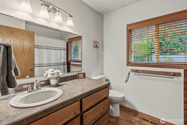 58 Pacific Pl, Longview, WA 98632 - full bath featuring toilet, vanity, wood finished floors, a shower with curtain, and baseboards