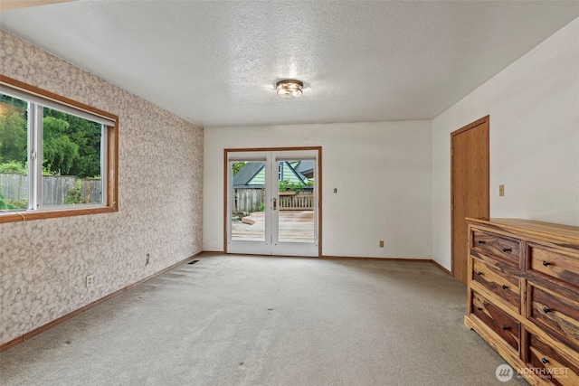 58 Pacific Pl, Longview, WA 98632 - empty room with light colored carpet, a textured ceiling, and baseboards