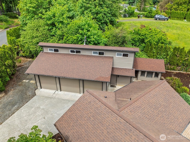 58 Pacific Pl, Longview, WA 98632 - view of front facade featuring concrete driveway, roof with shingles, and a garage