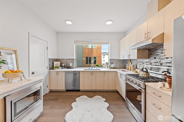 1478 159th Pl NE, Bellevue, WA 98008 - kitchen featuring stainless steel appliances, light brown cabinetry, under cabinet range hood, light countertops, and wood finished floors