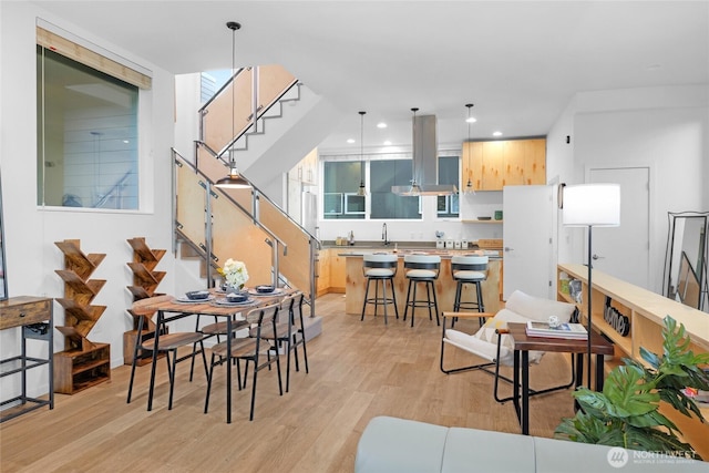 3427 22nd Ave W Unit A, Seattle, WA 98199 - dining space featuring light wood finished floors, stairs, and recessed lighting