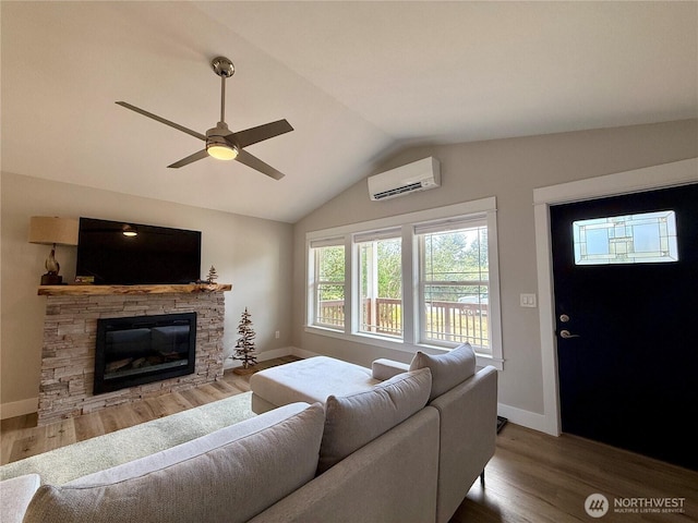 335 N Wynoochee Dr SW, Ocean Shores, WA 98569 - living room featuring an AC wall unit, lofted ceiling, baseboards, and wood finished floors