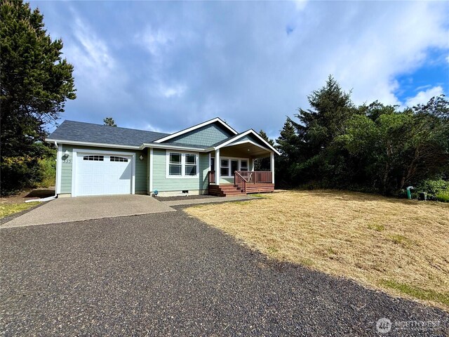 335 N Wynoochee Dr SW, Ocean Shores, WA 98569 - view of front of property with concrete driveway, an attached garage, covered porch, a front lawn, and crawl space