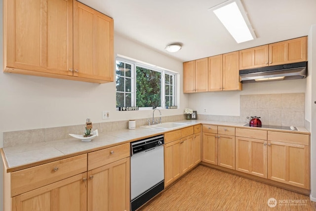 kitchen with dishwasher, under cabinet range hood, light brown cabinetry, and a sink