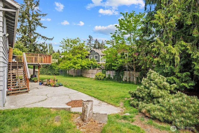view of yard with stairway, a patio, and a wooden deck