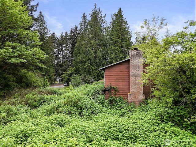 6811 128th St E, Puyallup, WA 98373 - view of property exterior featuring a chimney