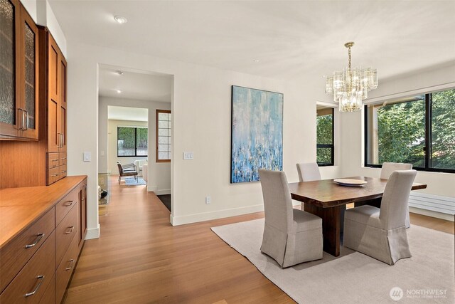 9120 NE 25th Pl, Clyde Hill, WA 98004 - dining area featuring light wood finished floors, a chandelier, baseboards, and recessed lighting