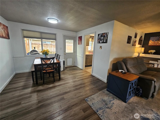 10915 Davisson Rd SW, Lakewood, WA 98499 - dining room featuring a textured ceiling, dark wood-style flooring, and baseboards