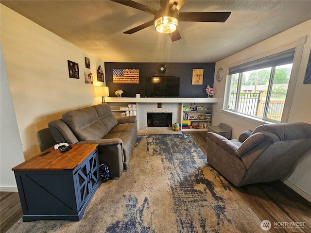 10915 Davisson Rd SW, Lakewood, WA 98499 - living area with wood finished floors, a ceiling fan, and a tile fireplace