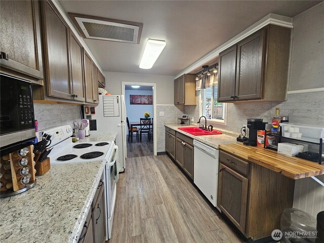 10915 Davisson Rd SW, Lakewood, WA 98499 - kitchen with white appliances, a sink, backsplash, and light wood-style flooring
