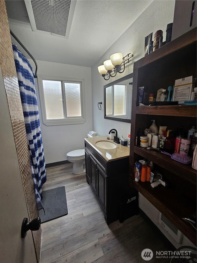 10915 Davisson Rd SW, Lakewood, WA 98499 - bathroom featuring toilet, vanity, wood finished floors, and a shower with shower curtain